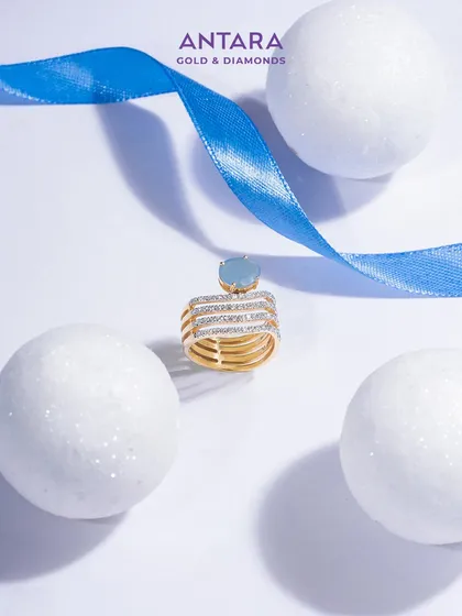 Where a diamond’s brilliance meets elegance. A serene blue aquamarine gemstone rests in a crown of gold, creating a ring that tells a story of rare beauty and unparalleled craftsmanship.