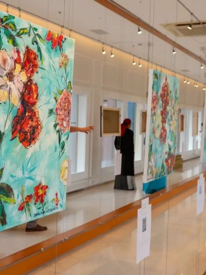 A gallery view of the '150 Years of Impressionism' exhibition, with large floral canvases creating a vibrant and immersive experience for visitors.