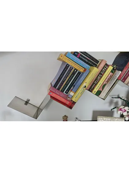 The polished steel of the shelves is subtle, putting the focus on the colorful books they hold.
