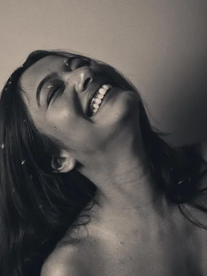 A moment of pure, unadulterated joy. In black and white, the emotion of the laugh becomes the absolute centerpiece of the image.