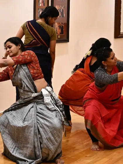 A rehearsal still from 'Songs of the Millstone', showing the dancers in a powerful, grounded pose. The choreography draws from the physicality of women's daily labour.