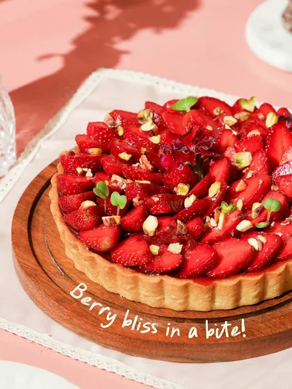Berry bliss in a bite! Our delightful strawberry tart features a buttery crust, creamy filling, and a beautiful arrangement of fresh strawberries topped with pistachios.
