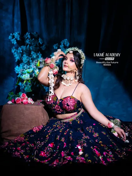 A full shot of our Haldi bride, showcasing the dark floral lehenga and a crown of fresh flowers. This look is a modern twist on a traditional ceremony, a style you'll learn to create.