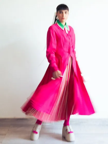 A motion-blur photo showing the vibrant color and movement of my pink Bodice dress, worn for their fashion show.
