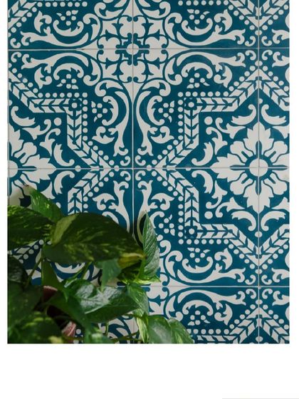 A close-up of the intricate blue and white tiles used in the bathroom, adding a touch of Mediterranean charm.