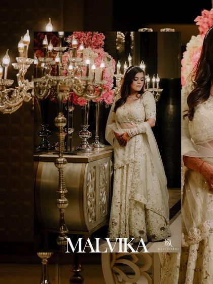 A beautiful portrait of the bride on her engagement day. The elegant decor and soft lighting highlight her stunning white lehenga and happy expression.