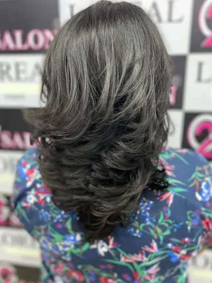 The final result of a step haircut, showing how the distinct layers build upon each other to create a fuller, more voluminous style.