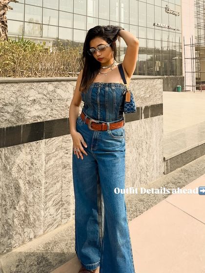 A full-length shot of the Y2K-inspired denim outfit. The wide-leg jeans and tube top create a very specific and trendy silhouette.