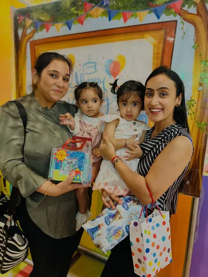 Posing for a photo after the birthday celebration. The smiles on everyone's faces, including the parents, show the warm, family-like atmosphere we cultivate.