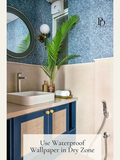 You don't need a full demolition to elevate a builder-grade bathroom. This space was transformed with simple but impactful additions like waterproof wallpaper in the dry zone, a chic mirror, and stylish wall sconces to add character and a custom-designed feel.