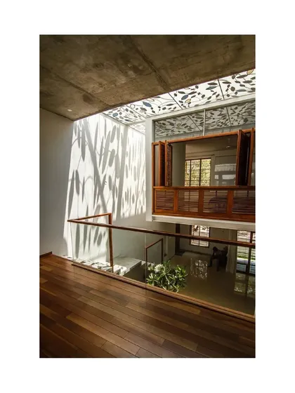 The play of light and shadow from the leaf-patterned skylight is a defining feature of the Cube Square house, transforming the interior with the changing angle of the sun.