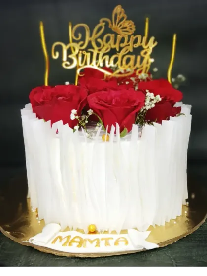 A trendy wafer paper cake for Mamta's birthday. This mixed fruit cake is adorned with fresh red roses and an elegant, textured wafer paper wrap.