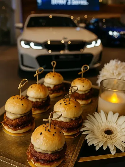 Miniature sliders served on a tray at the BMW 2 Series soiree. These gourmet bites are a perfect example of how we elevate classic comfort food for a sophisticated corporate audience, ensuring the menu is both approachable and impressive.