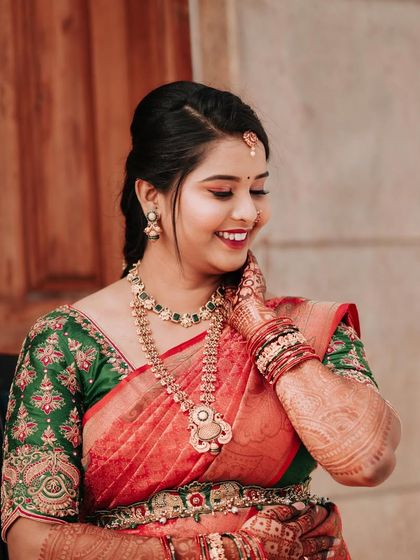 A happy, candid moment from Madhushree's engagement. Her makeup is a beautiful blend of traditional and modern, with a pop of color on the eyes.