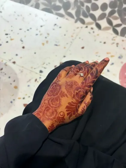 A beautiful, dark rose-themed henna stain on the back of the hand. This shows the rich color my organic henna achieves after a couple of days.