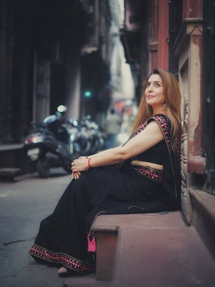 A moody and atmospheric portrait in the narrow lanes of Old Delhi. The black saree and her thoughtful expression create a cinematic feel, telling a story of the city's hidden corners.