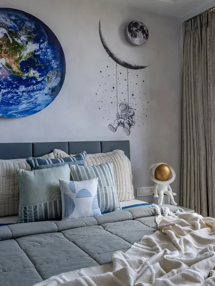 I love crafting personalized themed rooms, like this bedroom for a little explorer. The space-themed wall art, featuring a vivid Earth mural and a dreamy astronaut, is designed to fuel imagination, creating an inspiring space for big dreams and bedtime stories.