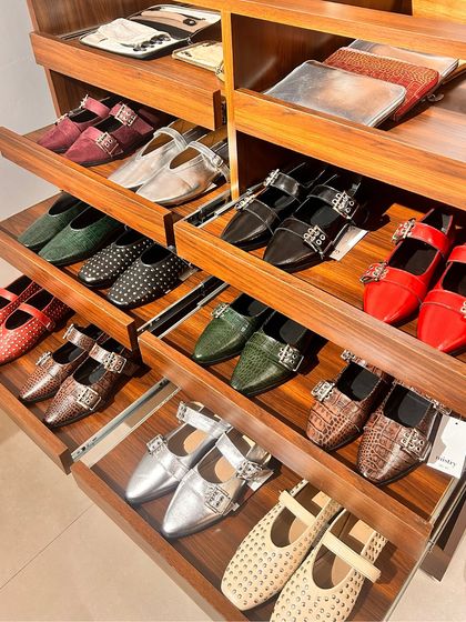 A look inside the drawers of my GK 1 store, filled with a variety of my embellished and buckled ballet flats. You can see the range of colors and textures, from studded black to croc-embossed green and metallic silver.
