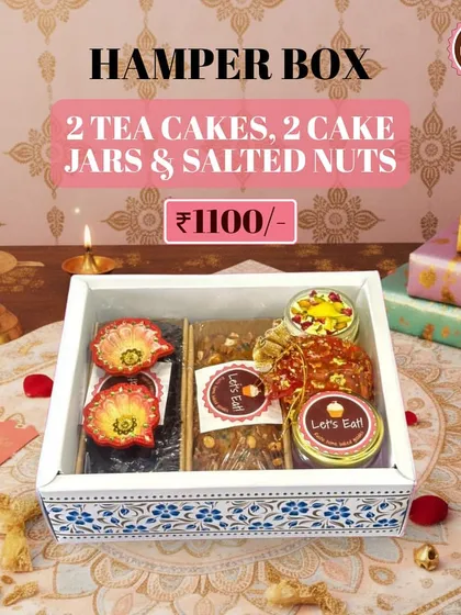 This Hamper Box is a delightful mix of sweet treats, featuring two tea cakes, two cake jars, and a jar of salted nuts, making it a perfect gift for friends and family.