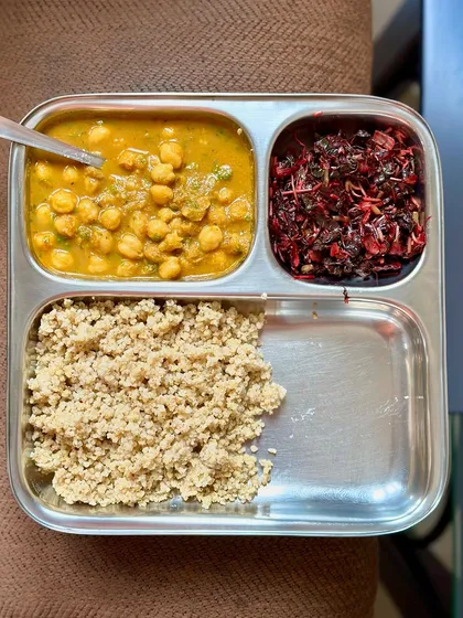A gluten-free meal of foxtail millet, channa masala, and sautéed amaranth leaves. This is a great example of a balanced and nutritious plant-based meal.