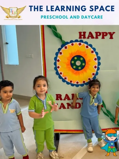 Happy faces in front of our Raksha Bandhan banner. The children proudly showcase the festive decorations they helped create, fostering a sense of ownership and pride.