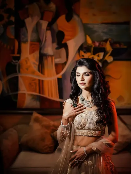 A thoughtful and artistic portrait of the bride, set against a colorful painting.