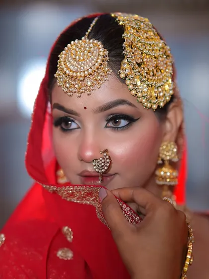 A close-up portrait of this stunning Sikh bride. The eye makeup is bold and defined, a signature element of this traditional look.