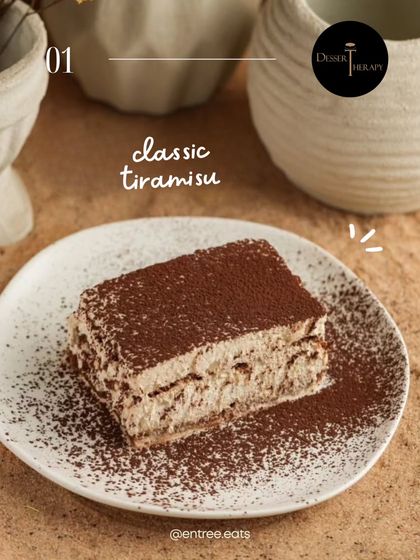 A classic tiramisu, beautifully plated and dusted with cocoa. This shot is simple, elegant, and focuses entirely on the dessert, making it look timeless and delicious. Perfect for a restaurant menu.