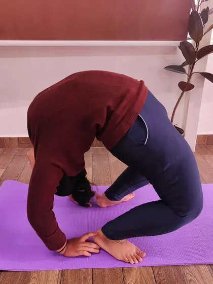 This student is holding a strong Poorna Chakrasana (Full Wheel Pose). Her form shows excellent shoulder opening and spinal flexibility, which we build gradually and safely in our classes.