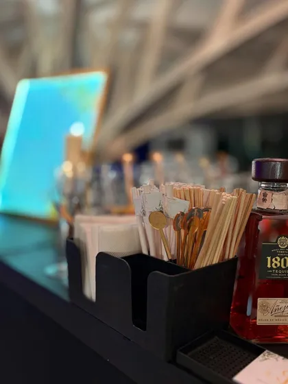Even the bar caddy is styled to perfection. Here, custom stirrers are neatly arranged next to a premium bottle of tequila, ready for a busy night of service.