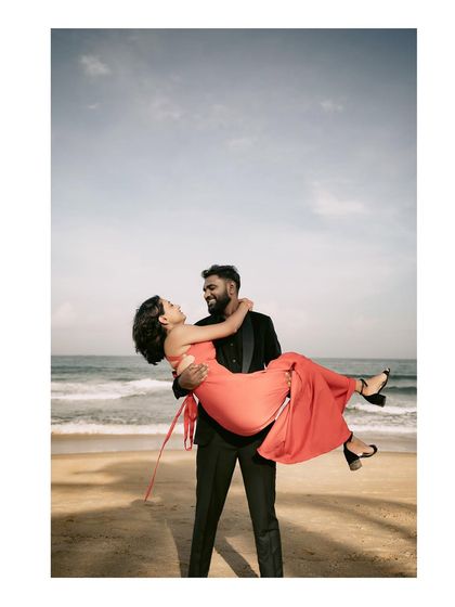 A classic romantic lift on the beach, with the sea and sky creating a perfect backdrop for this joyful post-wedding photo.