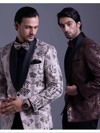 Two examples of statement dinner jackets. On the left, a snakeskin print jacquard, and on the right, a shimmering bronze textured jacket, both with classic black satin lapels.