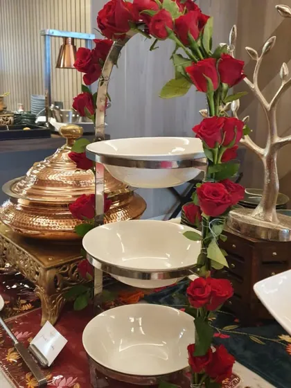 A close-up of the tiered serving stand adorned with red roses. This highlights the beautiful integration of floral decor and serveware that is a signature of my high-end setups.