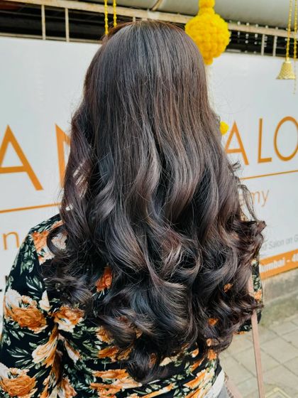 The back view of this global colour styled with waves shows off the volume and healthy condition of the hair.