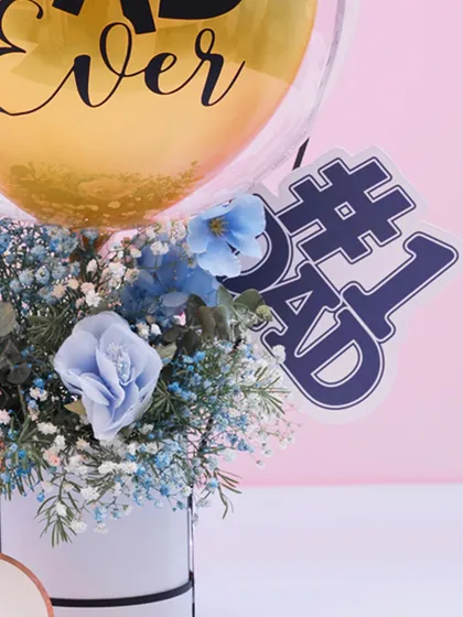 A close-up of the "#1 Dad" tag on a miniature floral bouquet. It's these little details that make a gift feel extra thoughtful and special.
