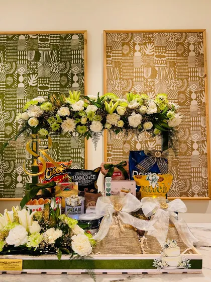 A closer look at the gourmet tray from the Roka celebration, overflowing with artisanal treats and fine nibbles, all crowned with a stunning fresh floral arrangement.