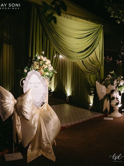 Big bows everywhere you looked. For this cocktail party, I designed an entrance with dramatic green draping and oversized satin bows to create a sense of fun, style, and celebration.
