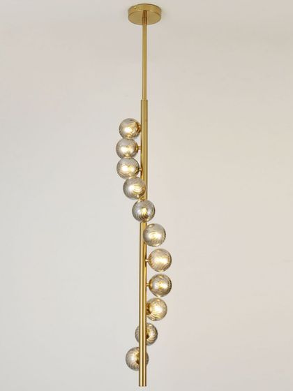 A vertical spiral pendant with smoked glass globes. This is a sleek and modern solution for narrow spaces or stairwells.