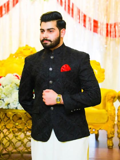 This groom looks regal and confident. The textured black jacket is a statement piece, perfect for making an impression at the reception.