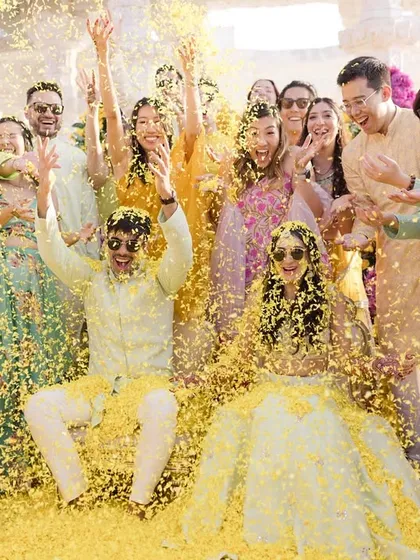 The pure, unadulterated joy of a Haldi ceremony. This is the kind of happy chaos I live for, where friends and family come together to shower the couple in love, laughter, and a whole lot of flower petals.