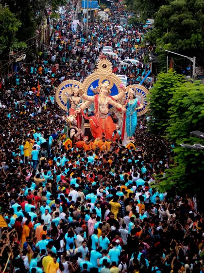 Another stunning wide shot from above, showing a sea of devotees in matching colors, a testament to the community spirit during the Ganpati festival.