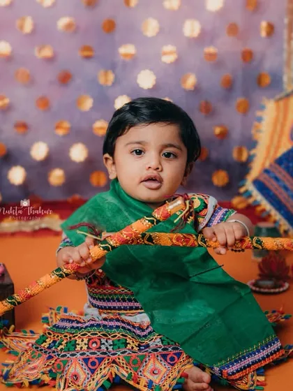 Holding her dandiya sticks, this little cutie is ready for the Garba celebration. I love capturing the spirit of Indian festivals.