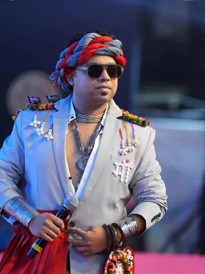 Holding the mic, ready to electrify the crowd. This look from Day 6 of Navratri features a custom jacket with traditional elements, showcasing my unique style.