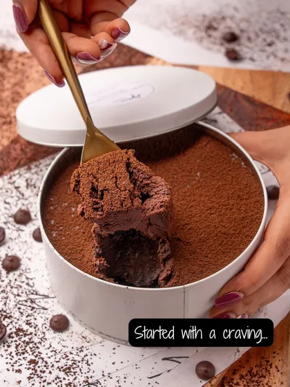 It all starts with a craving. A spoonful of our decadent chocolate mousse cake, showing its rich, airy texture. This is pure indulgence in a tin.