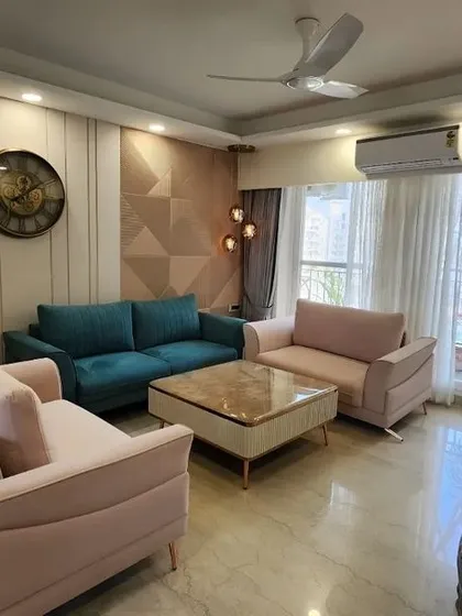 This living room project showcases a timeless elegance with a color palette of beige, cream, and pops of teal and floral. The design focuses on clean lines and comfortable furniture to create a space that is both beautiful and inviting.