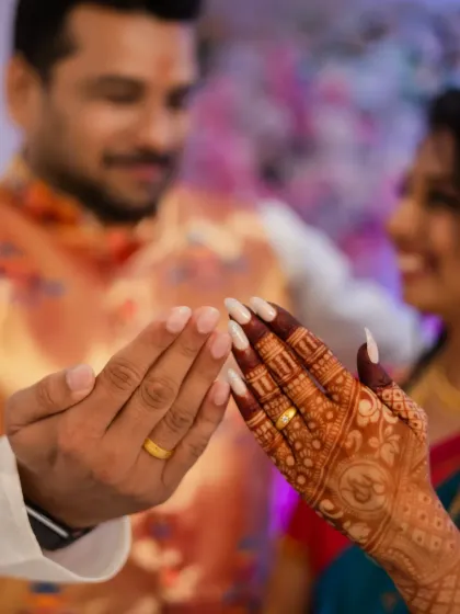 It's all in the details. A close-up of the engagement rings and the bride's intricate mehendi design, showcasing the beautiful traditions of a Maharashtrian ceremony.