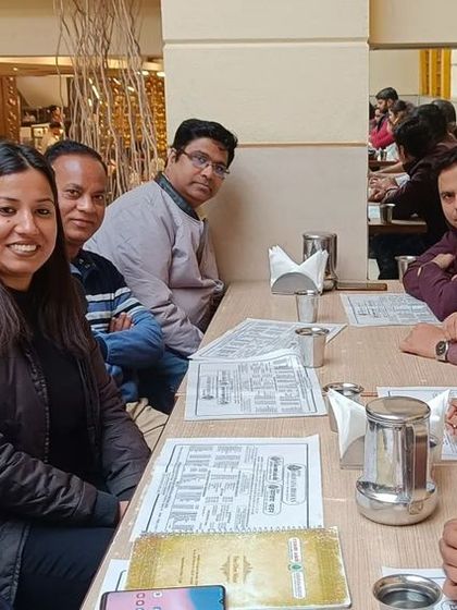 A casual team meeting over lunch with senior and junior advocates. These informal discussions are often very productive.
