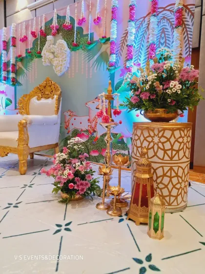 A close-up of the decorative elements, including brass lamps, floral arrangements in brass urns, and Moroccan-style lanterns that add a touch of elegance.