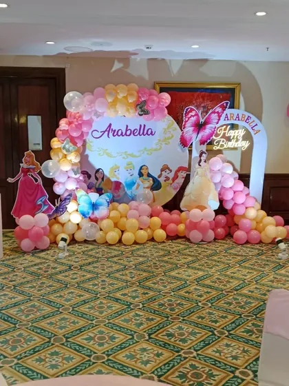 Another angle of the Disney Princess "Arabella" birthday setup, showing the full backdrop with multiple princesses and balloon arrangements.