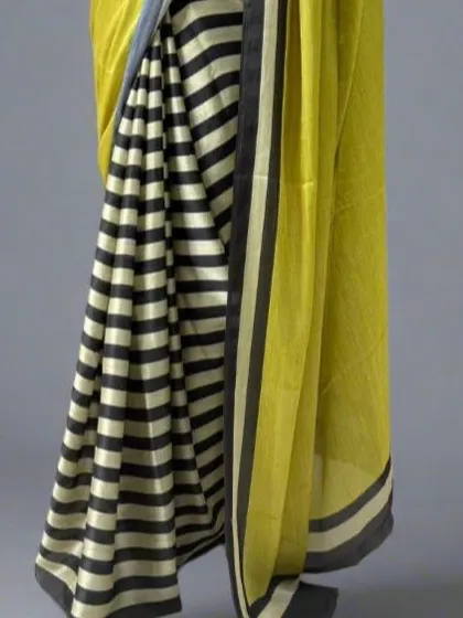 A close-up of the black and white striped portion of the saree, highlighting the clean lines and satin finish.